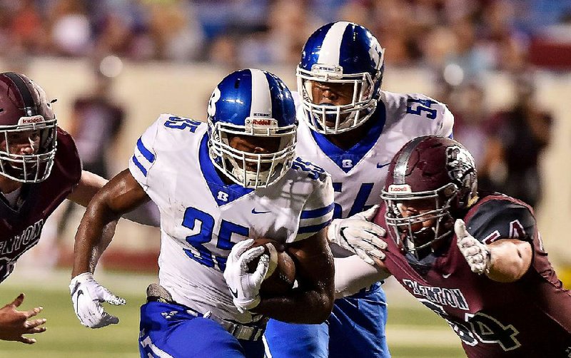 Bryant running back Ahmad Adams (35) runs for a first down past Benton defensive tackle Caleb Coffman (54) during the Salt Bowl on Friday night at War Memorial Stadium in Little Rock. Bryant won 42-14. See more photos at arkansasonline.com/galleries. 