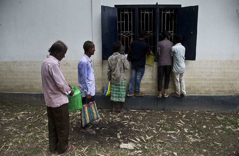 Villagers line up Saturday to see if their names are on the final list of the National Register of Citizens in the eastern Indian state of Assam. 