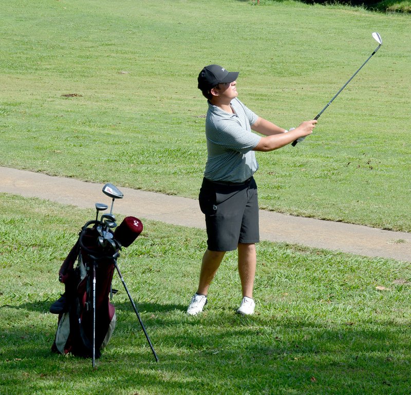 Graham Thomas/Siloam Sunday Siloam Springs junior Chris Svebek watches after hitting the ball on No. 9 during Wednesday's match at the Course at Sager's Crossing.