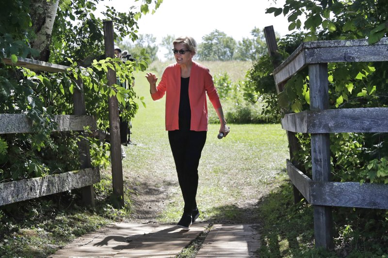 FILE - In this Aug. 14, 2019, file photo, Democratic presidential candidate Sen. Elizabeth Warren, D-Mass., waves as she arrives at a campaign event in Franconia, N.H. Three Democrats in their 70s are vying to challenge the oldest first-term president in U.S. history. But science says age isn't a proxy for fitness. The bigger question is how healthy you are and how well you function. With only a few years separating them, President Donald Trump at 73 has mocked former Vice President Joe Biden, 76. Biden and Sen. Bernie Sanders, 77, try to showcase physical activity on the campaign trial while the 70-year-old Warren even jogs around at rallies. (AP Photo/Elise Amendola, File)