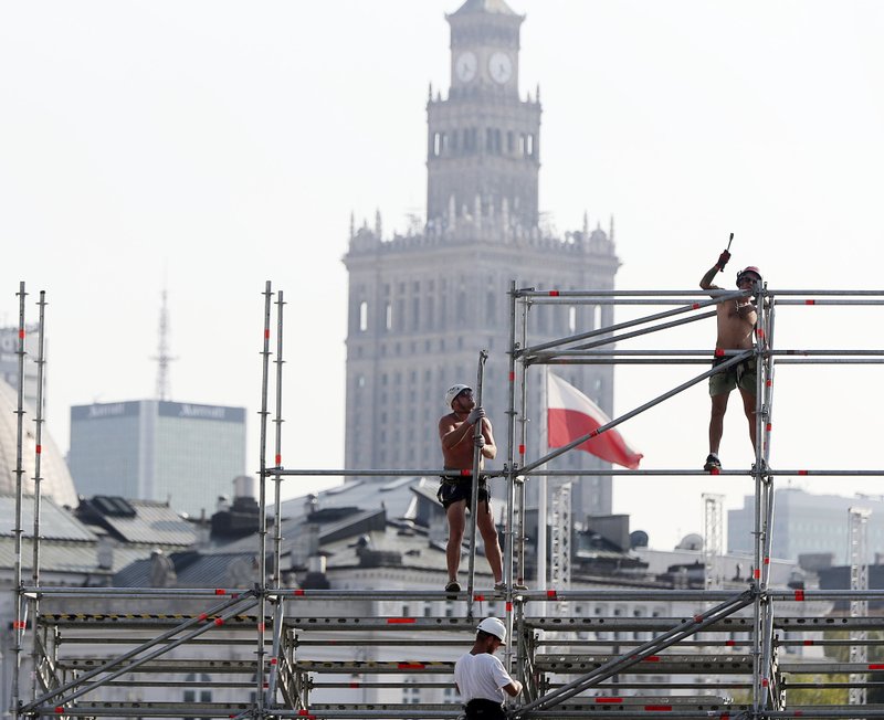 FILE - In this Wednesday, Aug. 28, 2019 file photo, workers erect a stage ahead of upcoming ceremonies marking the 80th anniversary of the start of World War II, in Warsaw, Poland. In Poland and across Eastern Europe, many feel that their people&#x2019;s suffering has never been adequately recognized, or that they have been unfairly tarnished for their behavior at that time, grievances politicians have been exploiting to promote myths of national innocence in a new age of nationalism. (AP Photo/Czarek Sokolowski)