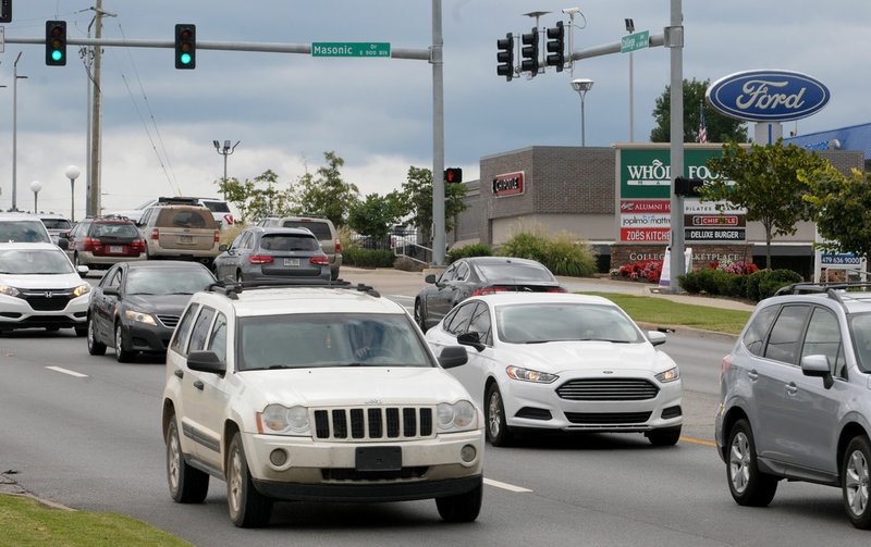 File photo/NWA Arkansas Democrat-Gazette/DAVID GOTTSCHALK Traffic moves in September 2018 through the intersection of College Avenue and Masonic Drive in Fayetteville. The city and Arkansas Department of Transportation have an agreement in place for the city to take ownership of the highway from the North Fulbright Expressway to the South Fulbright Expressway.