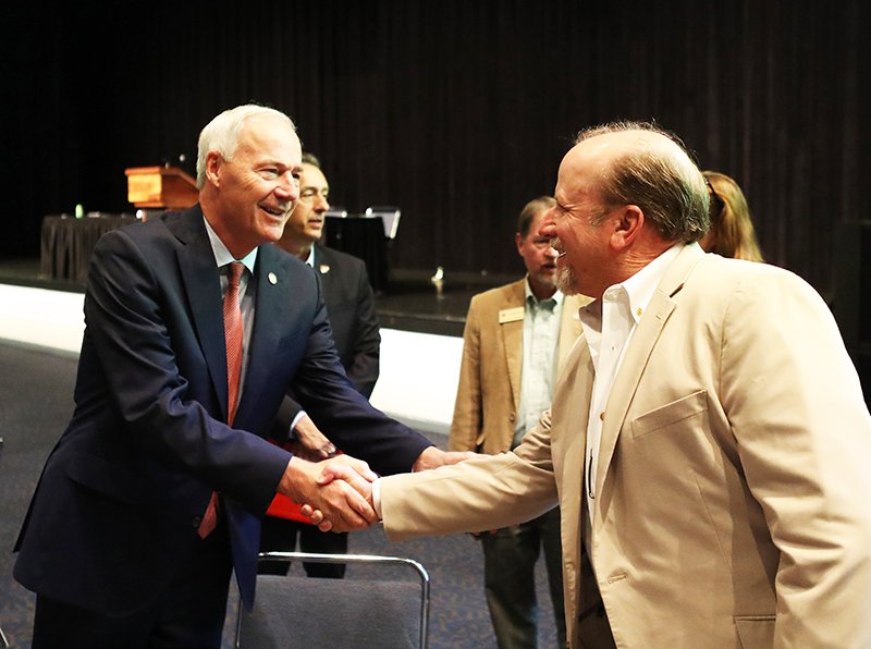 The Sentinel-Record/Richard Rasmussen WELCOME: Gov. Asa Hutchinson shakes hands with Garland County Judge Darryl Mahoney prior to speaking at the Arkansas Emergency Management Association Conference at the Hot Springs Convention Center on Wednesday.