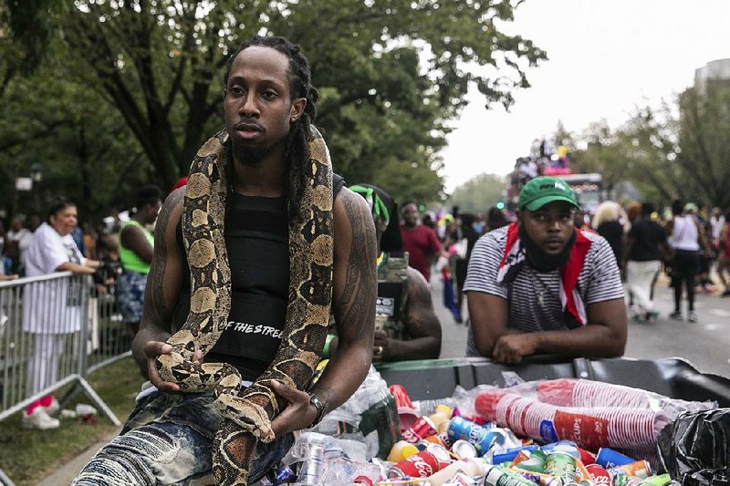 A man with a snake participates Monday in the West Indian American Day Parade in the Brooklyn borough of New York. 