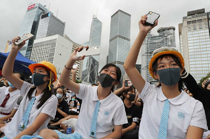 Students wear protective gear Monday as they protest in Hong Kong. 