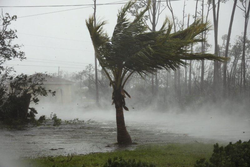 A road is flooded during the passing of Hurricane Dorian in Freeport, Grand Bahama, Bahamas, Monday, Sept. 2, 2019. Hurricane Dorian hovered over the Bahamas on Monday, pummeling the islands with a fearsome Category 4 assault that forced even rescue crews to take shelter until the onslaught passes. (AP Photo/Tim Aylen)
