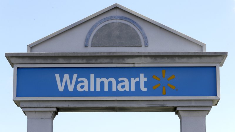 A Walmart logo forms part of a sign outside a Walmart store, Tuesday, Sept. 3, 2019, in Walpole, Mass. Walmart is going back to its folksy hunting heritage and getting rid of anything that's not related to a hunting rifle after two mass shootings in its stores in one week left 24 people dead in August of 2019. 