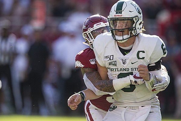 Arkansas defensive back Greg Brooks hits Portland State quarterback Davis Alexander from behind during a game Saturday, Aug. 31, 2019, in Fayetteville. 