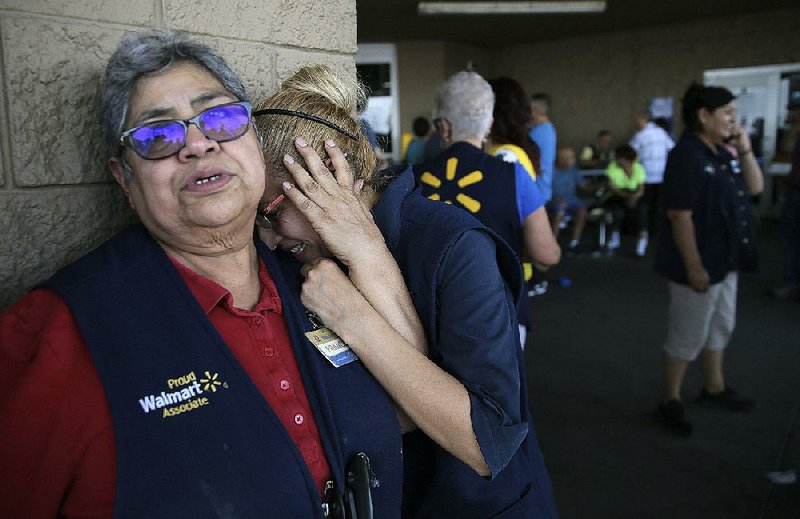 Walmart employees console each other Aug. 3 at a Walmart store in El Paso, Texas, in the aftermath of the shooting there that killed 22 people. 