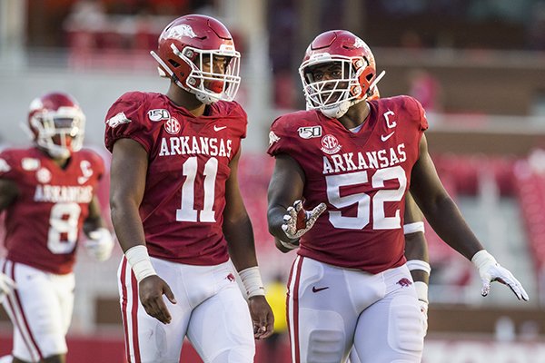 Arkansas defensive end Mataio Soli (11) listens as defensive tackle T.J. Smith (52) talks during a game against Portland State on Saturday, Aug. 31, 2019, in Fayetteville. 