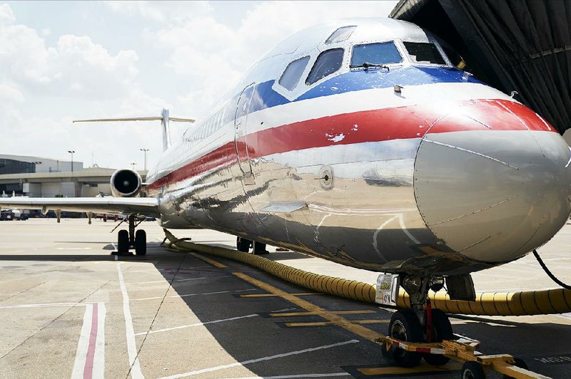 An American Airlines MD-80 aircraft sits at a gate Sunday at Dallas/Fort Worth International Airport. On Wednesday, after 36 years, the airline made its last MD-80 commercial trip, flying from Dallas to Chicago. 