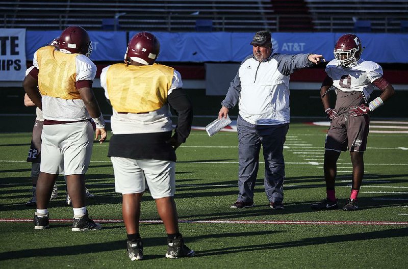 Magnolia Coach Mark King (second from right), shown coaching Foreman before the Class 2A state championship game in 2017, is trying to change the culture with the Panthers, but discipline and conditioning were key issues in their loss to Warren on Aug. 27. 