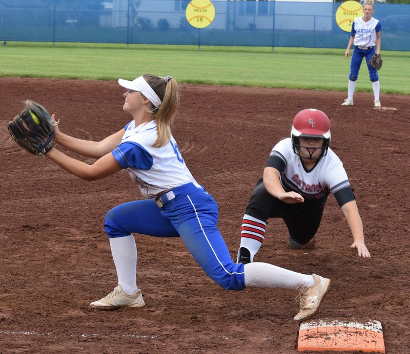 RICK PECK/SPECIAL TO MCDONALD COUNTY PRESS McDonald County's Kaylee Eberley gets forced out at first base during the Lady Mustangs' 5-1 win over Carthage on Aug. 31 at Carthage High School in the 2019 season opener.