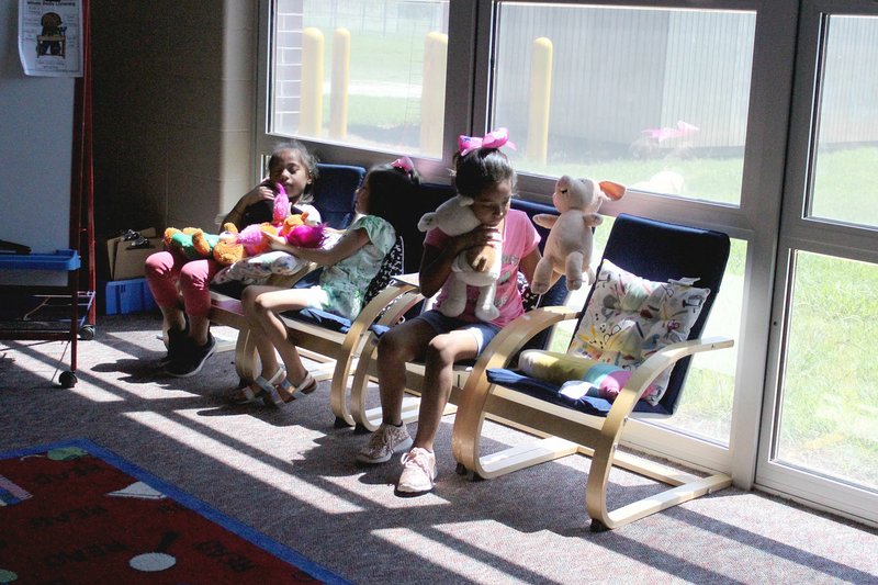 MEGAN DAVIS/MCDONALD COUNTY PRESS Three young girls find relaxation and recreation in the Noel Primary Library during the power outage on Tuesday. There may not have been electricity, but there were hushed giggles and conversation all around.