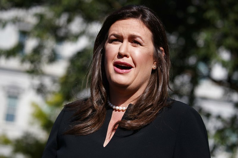In this June 11, 2019 file photo, former White House press secretary Sarah Sanders talks with reporters outside the White House in Washington. 