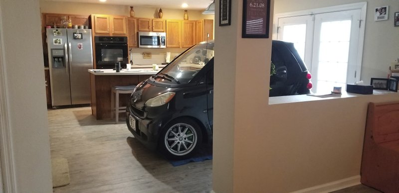 In this Sept. 3, 2019 photo made available by Jessica Eldridge shows her husband's Smart car parked in their kitchen in Jacksonville, Fla. Patrick Eldridge parked his Smart car in his kitchen to protect it from Hurricane Dorian. In a Facebook post, Jessica Eldridge said her husband was "afraid his car might blow away" so he parked it in their Jacksonville home's kitchen. (Jessica Eldridge via AP)
story.lead_photo.caption