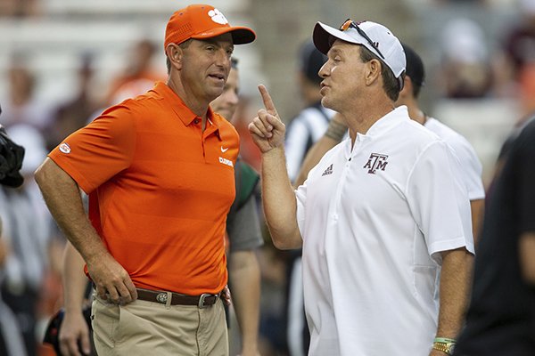 Clemson head coach Dabo Swinney and Texas A&M head coach Jimbo Fisher talk before the start of an NCAA college football game Saturday, Sept. 8, 2018, in College Station, Texas. (AP Photo/Sam Craft)