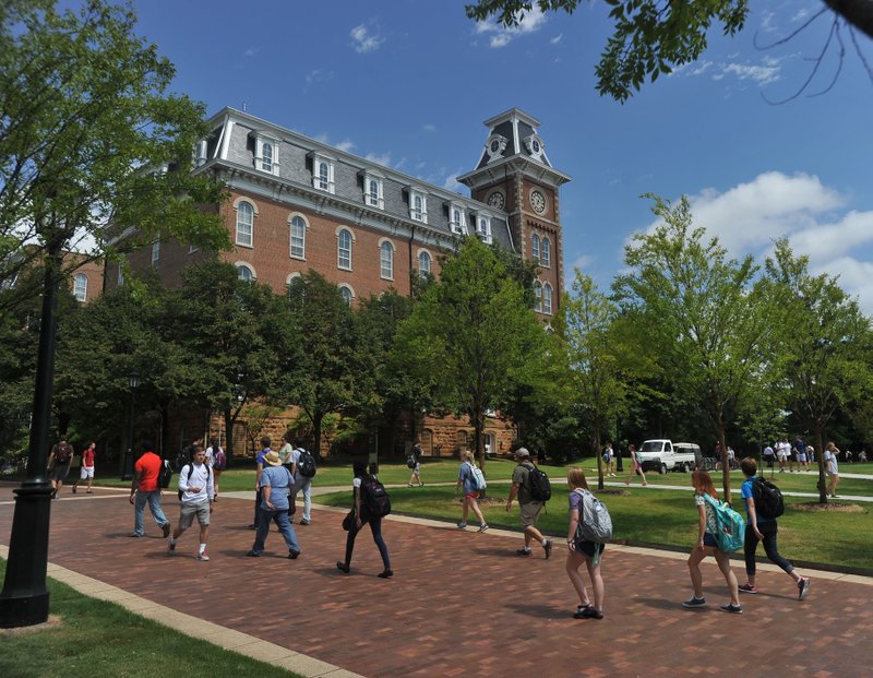 University of Arkansas students walk past Old Main on the U of A campus in Fayetteville in this 2014 photo.