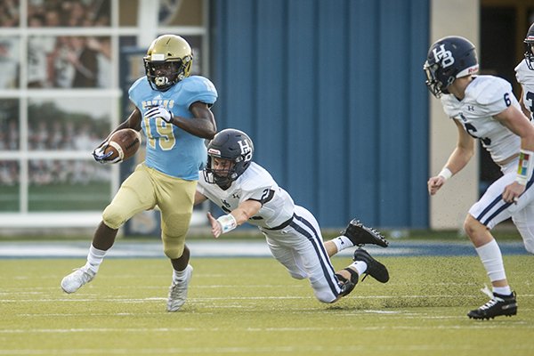 Pulaski Academy running back Joe Himson (19) breaks a tackle during a game against Springdale Har-Ber on Thursday, Aug. 29, 2019, at Joe B. Hatcher Stadium in Little Rock. 