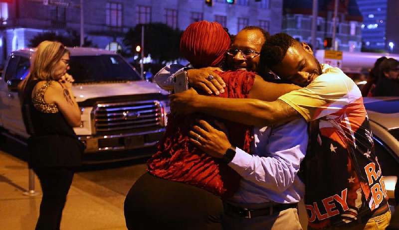 Brenda Woods (from left), Rizelle Aaron and Montreal Ussery, relatives of Bradley Blackshire, embrace Wednesday outside City Hall after the Little Rock Civil Service Commission ruled that Charles Starks would not be reinstated to the Little Rock police force.