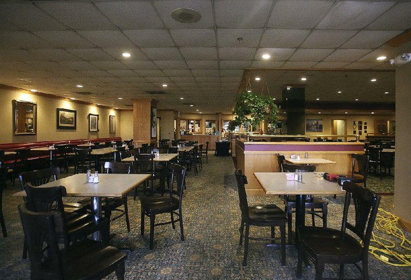 Tables sit empty in the dining area of Franke’s Cafeteria during lunch hour Thursday in the Regions Center Building in downtown Little Rock. 