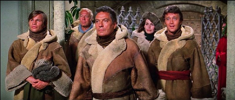 In from the cold: Captives (from left) George Conway (Michael York), Sam Cornelius (George Kennedy), Richard Conway (Peter Finch), Sally Hughes (Sally Kellerman) and Harry Lovett (Bobby Van) arrive at Shangri-La ready to sing and dance their way to tedium in the disastrous musical Lost Horizon (1973). 