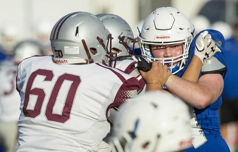 NWA Democrat-Gazette/BEN GOFF @NWABENGOFF Aaron Lockhart, Rogers defensive end, looks to shake an offensive lineman during a preseason scrimmage against Siloam Springs at Blackhawk Stadium in Pea Ridge. Lockhart has gained significant weight in the offseason and will be a starter for the Mounties despite battling Diabetes.