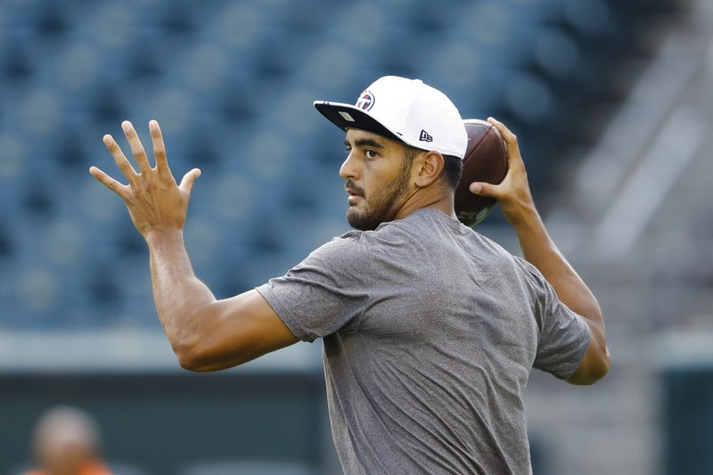 FILE - In this Aug. 8, 2019, file photo, Tennessee Titans quarterback Marcus Mariota warms up before a preseason NFL football game in Philadelphia. Tennessee plays at Cleveland on Sunday. (AP Photo/Matt Rourke, Fle)