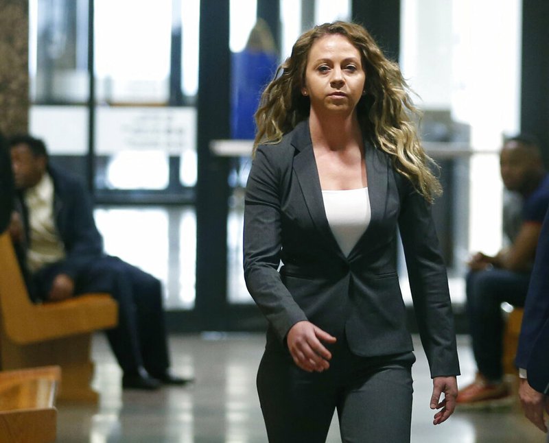 In this March 18, 2019 file photo, former Dallas Police officer Amber Guyger walks the hallway on her third court appearance at the Frank Crowley Courts Building in Dallas. Jury selection is set to begin, Friday, Sept. 6, in the trial of Guyger, charged with killing an unarmed black man in his own apartment. Guyger faces a murder charge in the slaying of Botham Jean. Guyger told authorities she mistakenly entered Jean's apartment thinking it was her own and fatally shot him. (Vernon Bryant/The Dallas Morning News via AP, File)