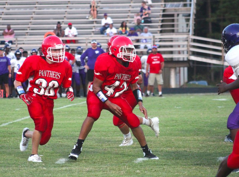 Magnolia freshman Jase Carter (42) and Jacob Hebert (30) provide protection for quarterback Dalen Blanchard during the Cubs victory over El Dorado Thursday. The Cubs will travel to Nashville next week to battle the Scrappers.