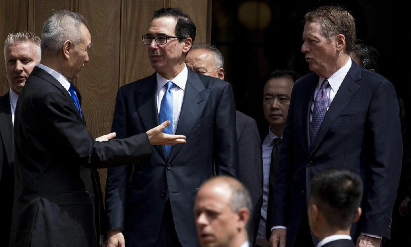 China’s chief trade envoy, Vice Premier Liu He (from left), talks with Treasury Secretary Steven Mnuchin and U.S. Trade Representative Robert Lighthizer during an unsuccessful round of talks in Washington in May. They plan to meet again in early October. 
