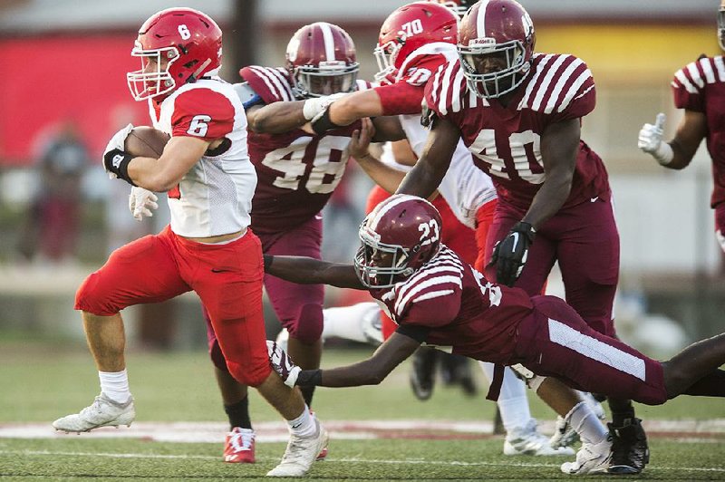 Cabot’s Graham Turner (left) evades a tackle by Pine Bluff’s Cason Blunt on Friday at Jordan Stadium in Pine Bluff. Cabot won 43-19.