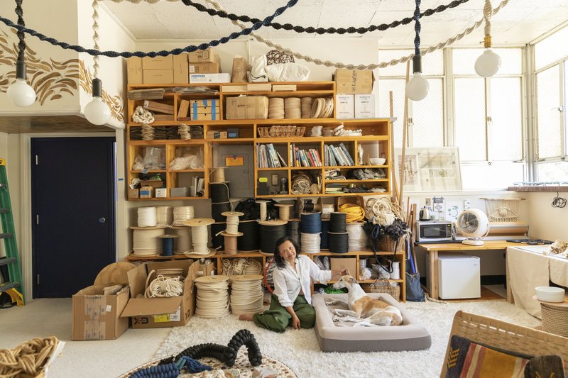 This undated photo provided by Chronicle Books shows a photo from the book "Creative Spaces" by Ted Vadakan and Angie Myung, featuring the creative space of Windy Chien, pictured, in San Francisco, Calif. (Ye Rin Mok/Chronicle Books via AP)