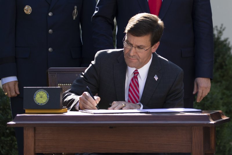 Secretary of Defense Mark Esper signs a document announcing the establishment of the U.S. Space Command during an event in the Rose Garden of the White House, Thursday, Aug. 29, 2019, in Washington. (AP Photo/Carolyn Kaster)