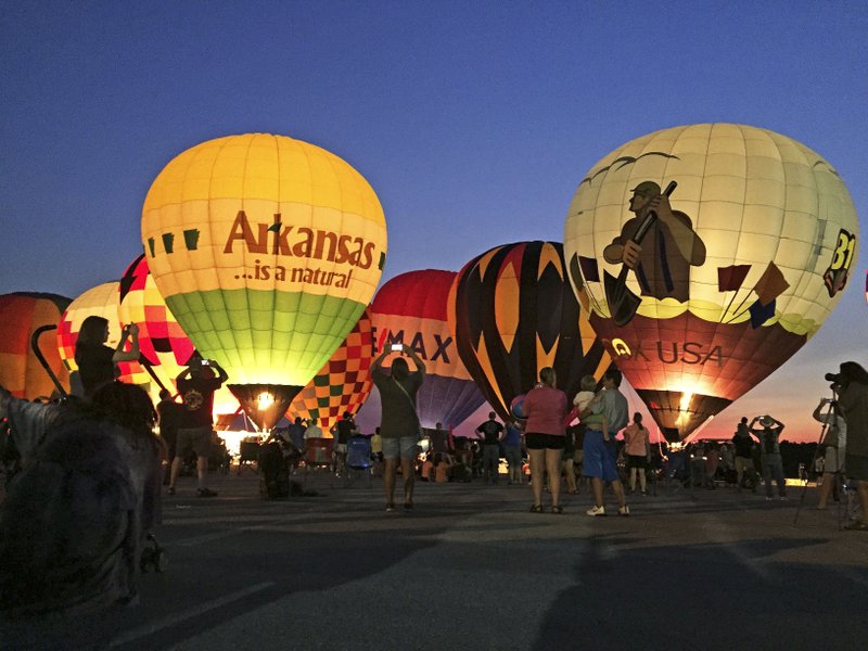 Arkansas Democrat-Gazette/BILL BOWDEN The annual Arkansas Hot Air Balloon State Championship kicked off Friday night with a balloon glow at the Boone County Regional Airport in Harrison. The event, which includes 11 teams of balloonists, continues through Sunday morning.