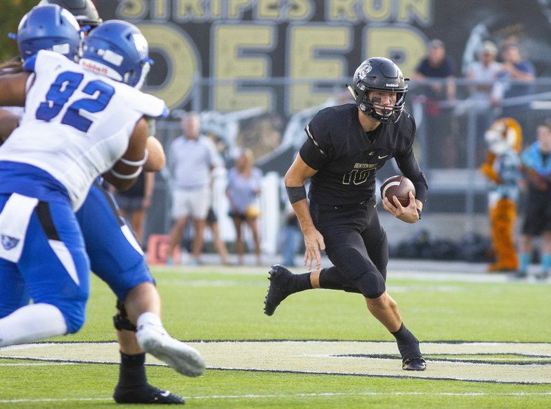Bentonville High’s Ben Pankau (right) runs down the field against Conway on Sept. 6 at Tiger Stadium in Bentonville. story.lead_photo.caption