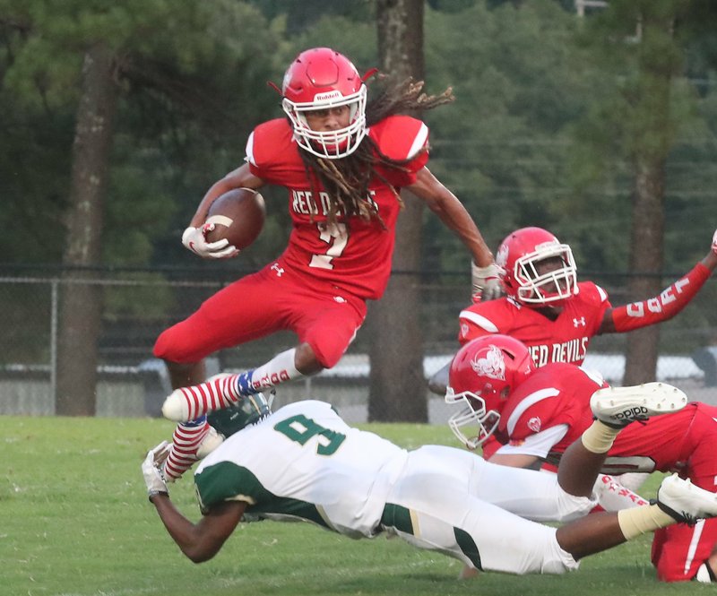 The Sentinel-Record/Richard Rasmussen LEAPING DEVIL: Mountain Pine senior receiver Kason Porter jumps Mineral Springs defender K’Anthony Brown (9) for a gain during first half action at Mountain Pine Friday. The Hornets won 40-32.