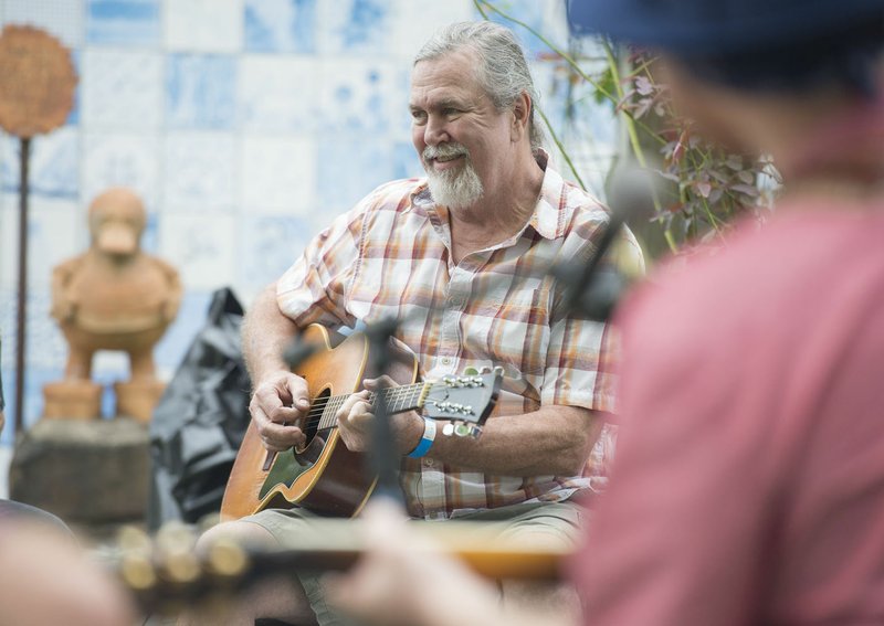 NWA Democrat-Gazette/J.T. WAMPLER Jim Mills of Fayetteville plays in a song circle during the Terra Studios Fall Music and Art Festival in 2018.