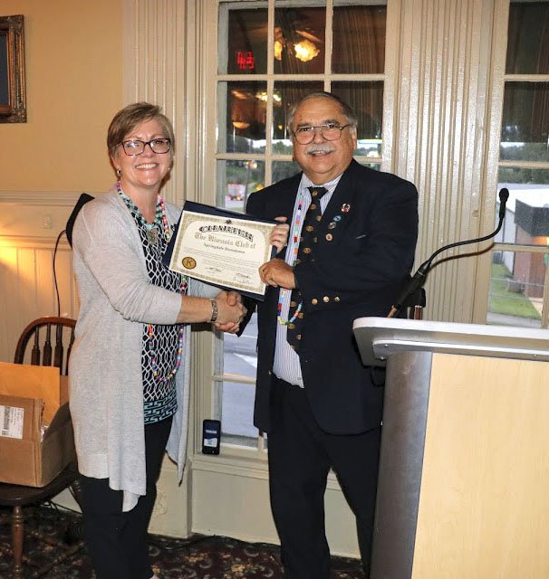 Courtesy photo The Springdale Downtown Kiwanis Club recently received its charter to be recognized as a Kiwanis Club. Shown is Missouri Arkansas District Governor Gary Baker as he presents the charter to new Club President Missha Waggoner. The new club will meet each third Thursday evening. Information: misshawaggoner@gmail.com.