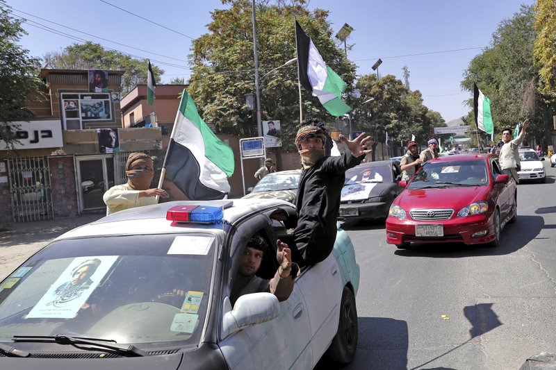 Afghans travel in convoy with cars decorated with black flags and portraits of late Commander Ahmad Shah Massoud marking the 18th anniversary of his death, in Kabul, Afghanistan, Monday, Sept. 9, 2019. Afghans are bracing for a possible new wave of Taliban violence after President Donald Trump abruptly called off talks with the insurgent group, which vows to continue its fight against what it calls "foreign occupation." (AP Photo/Ebrahim Noroozi)

