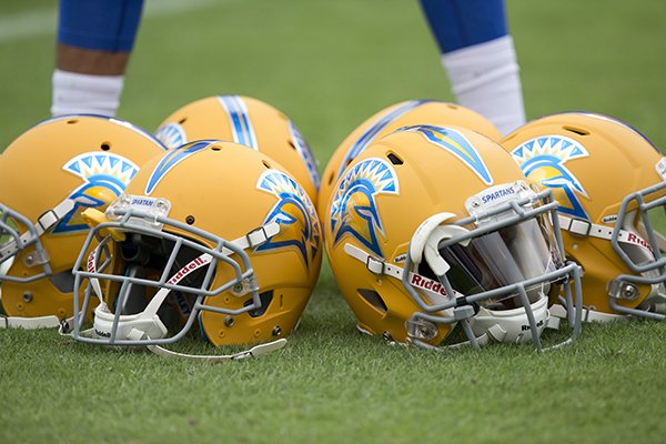 San Jose State helmets sit on the football field before an NCAA college football game against Auburn, Saturday, Oct. 3, 2015, in Auburn, Ala. (AP Photo/Brynn Anderson)