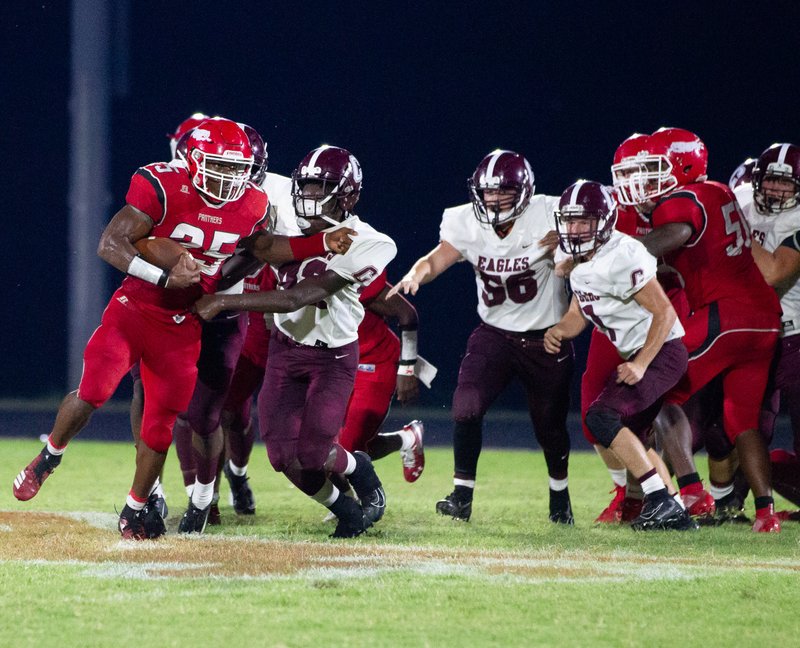 Magnolia RB DeMarco Walker (25) fends off tacklers late in the game against Crossett Friday night in the Panthers 36-30 come-from-behind win.   