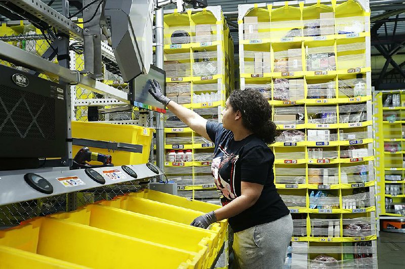 A worker sorts items and fulfills orders earlier this year at an Amazon facility in Staten Island, N.Y. The company, which has more than 650,000 workers worldwide, is the second-biggest U.S.-based private employer behind Walmart Inc. 