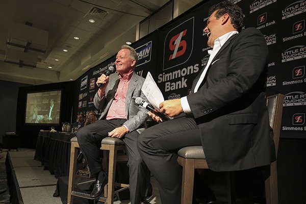 Former Arkansas football coach Bobby Petrino (left) and Little Rock Touchdown Club founder David Bazzel laugh during Petrino's speech to the club on Monday, Sept. 9, 2019, in Little Rock.