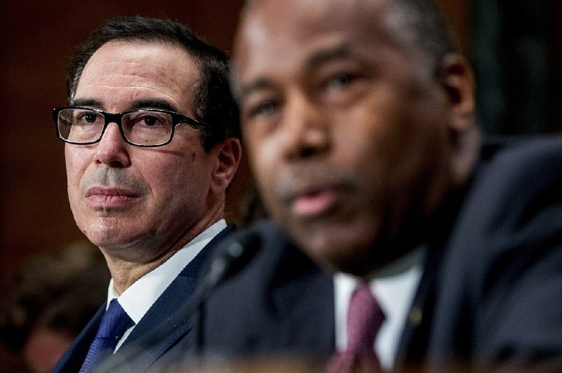 Treasury Secretary Steven Mnuchin (left) and Housing and Urban Development Secretary Ben Carson testify Tuesday in a Senate Banking Committee hearing. 