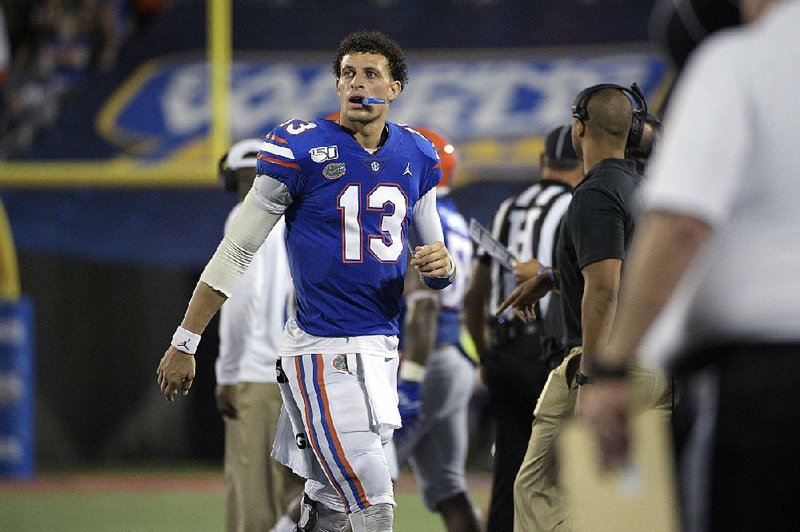 Florida quarterback Feleipe Franks (13) watches from the sideline during the second half of an NCAA college football game against Miami Saturday, Aug. 24, 2019, in Orlando, Fla. (AP Photo/Phelan M. Ebenhack)