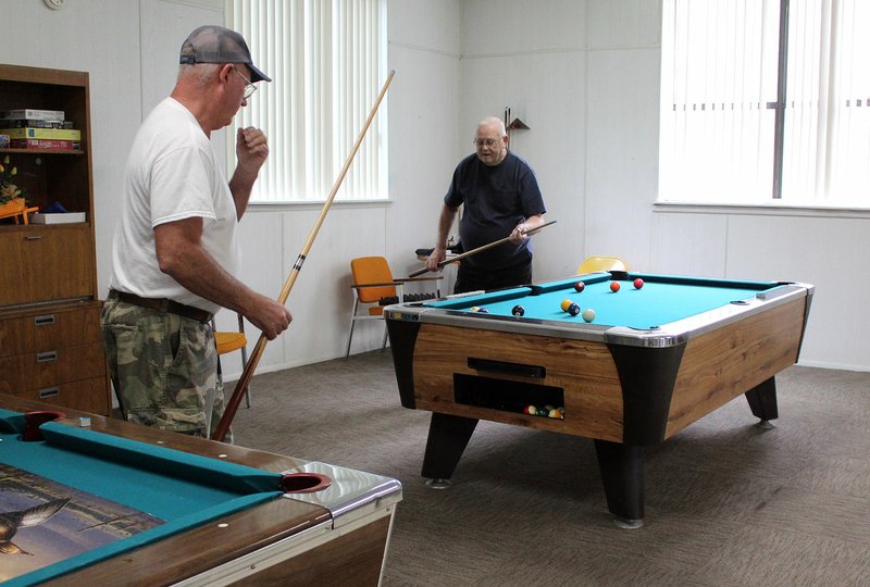 MEGAN DAVIS/MCDONALD COUNTY PRESS Bob Easter and Butch Merry enjoy a few games of pool following lunch at the Southwest City Senior Center on Friday, Aug. 30.