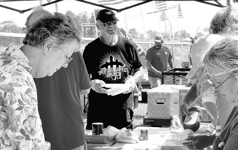 Sally Carroll File photo/McDonald County Press His Table Ministry and other volunteers pass out a free barbecue lunch at a past Ozark Orchard Festival. A free lunch will be available again this year at the event, set for Saturday, Sept. 28.