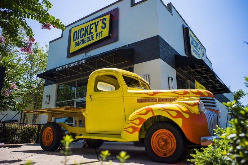A 1941 Chevy pickup, with the bed replaced by a table and some adorning flames on the front fenders, awaits customers of Dickey's Barbecue Pit, now open -- after several delays -- in the former Starbucks at 9401 N. Rodney Parham Road, Little Rock. Arkansas Democrat-Gazette/Jeff Gammons