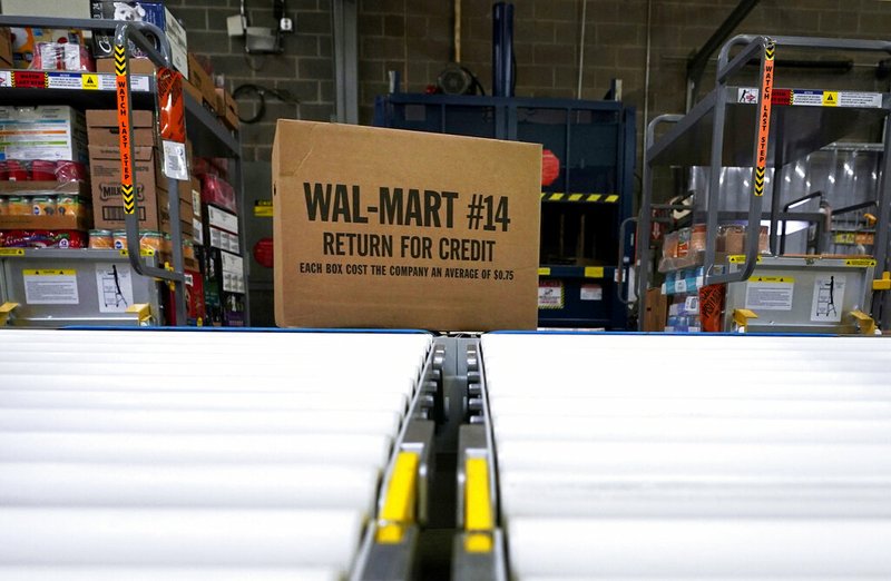 In this Nov. 9, 2018, file photo, a box of merchandise is unloaded from a truck and sent along a conveyor belt at a Walmart Supercenter in Houston. Walmart is rolling out an unlimited grocery delivery subscription service this fall for a $98 annual fee. The service will reach 1,400 stores in 200 markets and allows the nation's largest grocer to further tap into time-starved shoppers looking for convenience. (AP Photo/David J. Phillip, File)